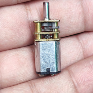 68RPM N20 DC Gear Motor - a close-up showing the silver metal motor body attached to a brass-colored gearbox with exposed gears and a rotating shaft.