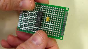 6x4cm 2.54mm Single Sided Universal Printed Circuit Board For DIY Soldering - with an integrated circuit and a small capacitor placed on it.