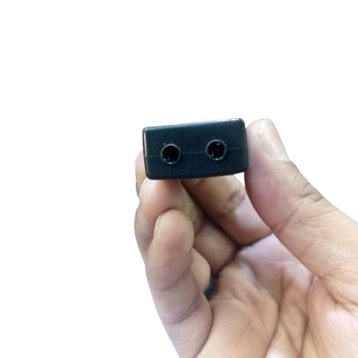7.1 Channel USB External Sound Adapter - a close-up showing the black rectangular end of the device with two circular audio ports held by a hand.