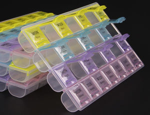 7 Days Weekly 28 Slots Travel Pill Box Organizer And Medicine Holder Case Medicine Organizer - multiple stacked, multi-colored plastic pill containers with daily labels printed on the lids.