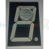 70mm Common Anode 7 Segment LED Display - a black rectangular component with white segments and a Pakistani 2-rupee coin placed on top for scale.