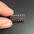 74147 HLF74HC147N 10-to-4 Line Priority Encoder IC - a black rectangular integrated circuit held by fingers, showing the printed model number.