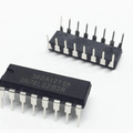 74LS283 - two black 16-pin dual in-line package integrated circuits with silver metal pins, shown from different angles on a white background.