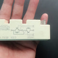 75A 1200V IGBT Module - a rectangular beige electronic component held in a hand, showing a printed circuit diagram and terminal pins on its side.