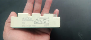 75A 1200V IGBT Module - a rectangular beige electronic component held in a hand, showing a printed circuit diagram and terminal pins on its side.
