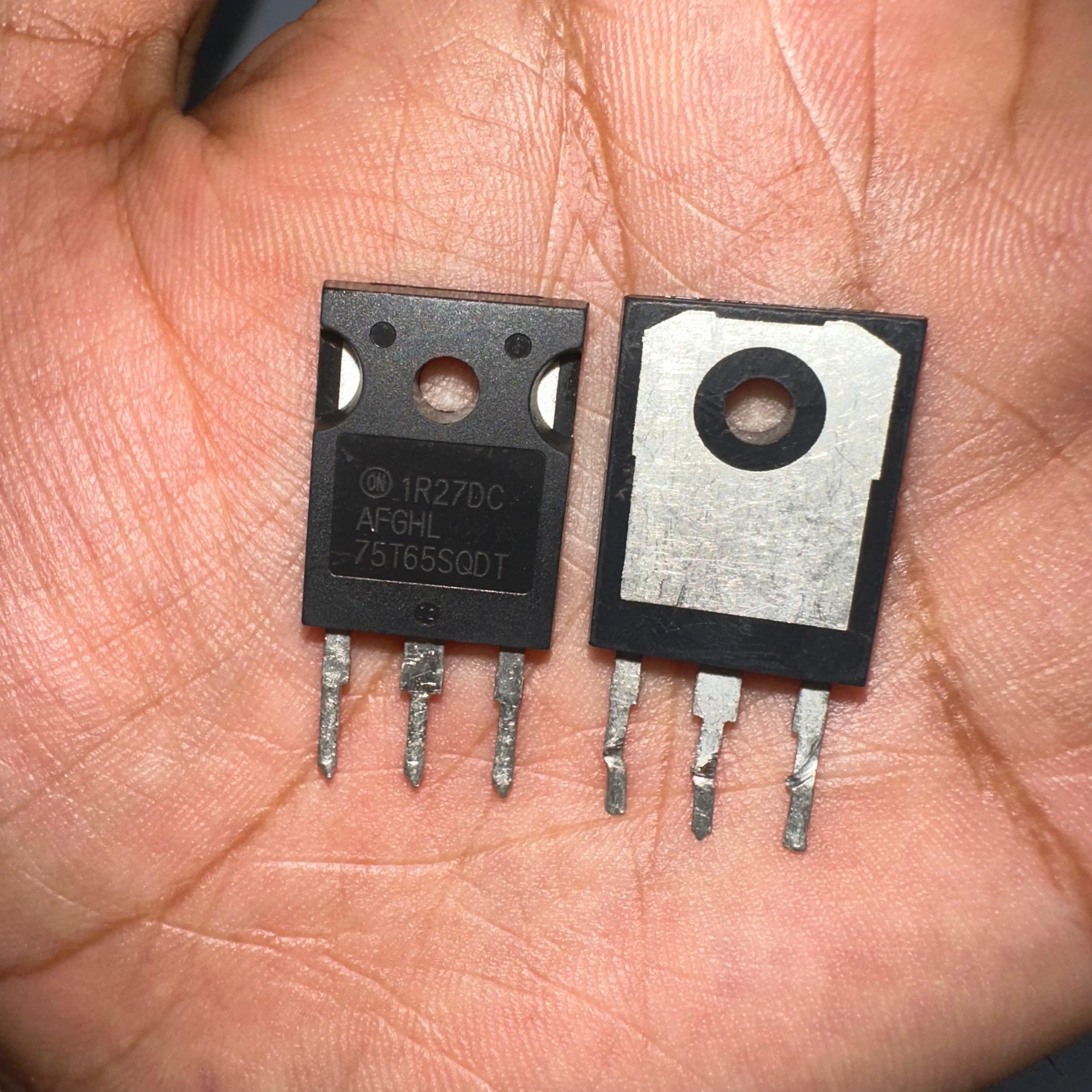 75A 650V On Semiconductor 75T65SQDT IGBT With Soft Fast Recovery Diode-digilog.pk - two black, three-pin electronic components held in a hand, showing the front with printed text and the metal back side.