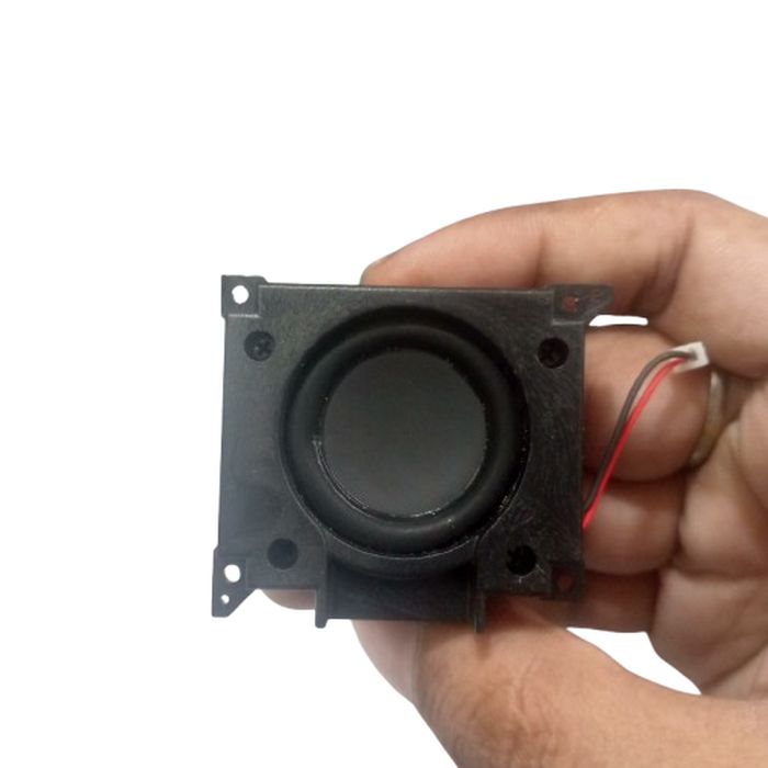 8 Ohm 1 watt Buffer speaker - a black square-framed speaker with a circular cone and a two-wire connector held in a hand.