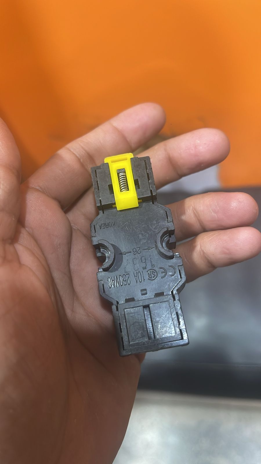 8 Pin Relay Socket Base Thick Copper 10A Mini Relay Socket Base - shown as a close-up of a black plastic relay base with a yellow spring-loaded clip held in a hand.