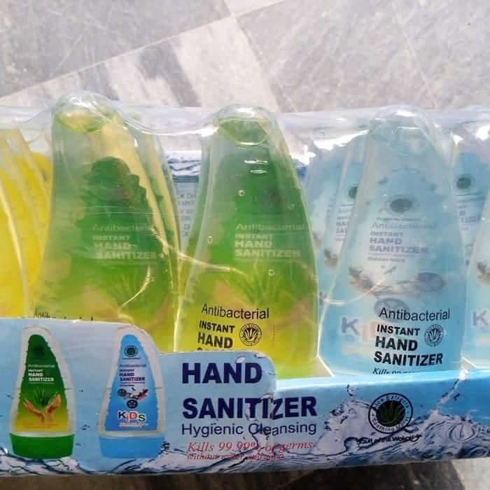 80ML Instant Liquid Soap Hand Sanitizer - shown in a retail display box containing multiple green and blue gel-filled bottles with pump dispensers.