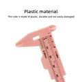 80mm Plastic Vernier Caliper | Dual Scale Mini Measuring Tool - a close-up of a pink plastic sliding measuring tool showing metric and imperial scale markings on its body.