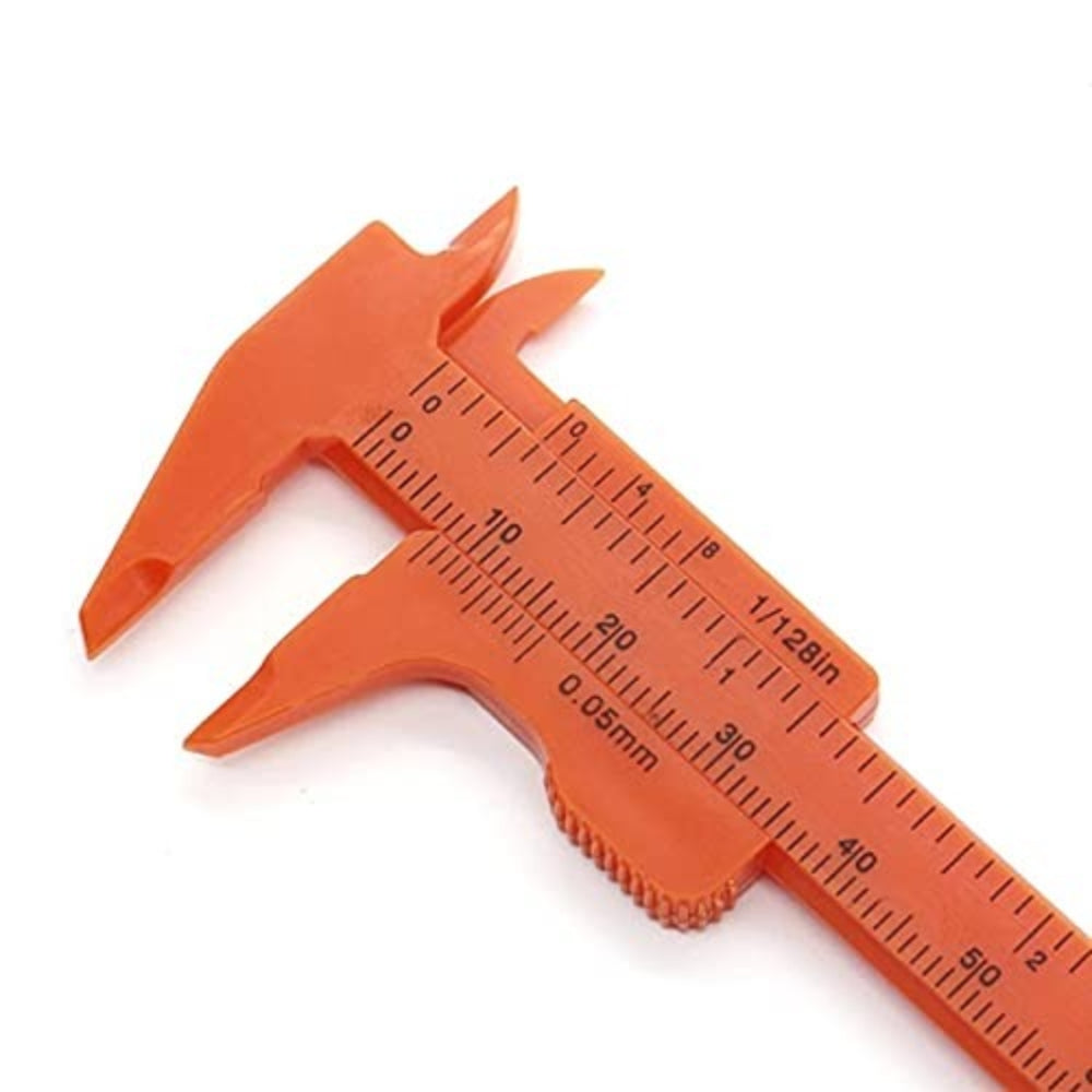 80mm Plastic Vernier Caliper | Dual Scale Mini Measuring Tool - a close-up view of the orange plastic measuring tool showing the dual scale markings in millimeters and inches.