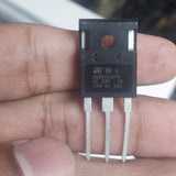 80N65 GW80H65 80H65 IGBT - a black three-pin electronic component held between fingers showing the ST logo and model markings printed on the front.