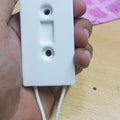 80W 20RJ Ceramic Power Braking Resistor VFD - close-up of a white rectangular ceramic component held in a hand with two white wires extending from it.