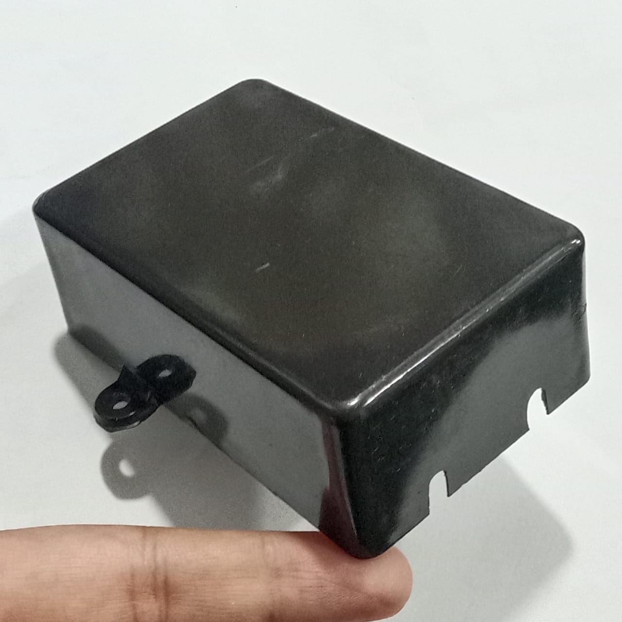 87mm x 55mm X33MM ABS Box PCB Enclosure Plastic Box Project Box - shown as a black rectangular plastic case with a mounting tab and two side cutouts.