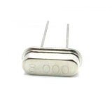 8MHz Crystal Oscillator - shown as a silver-coloured metal component with two thin wire leads and the number 8.000 printed on its front face.