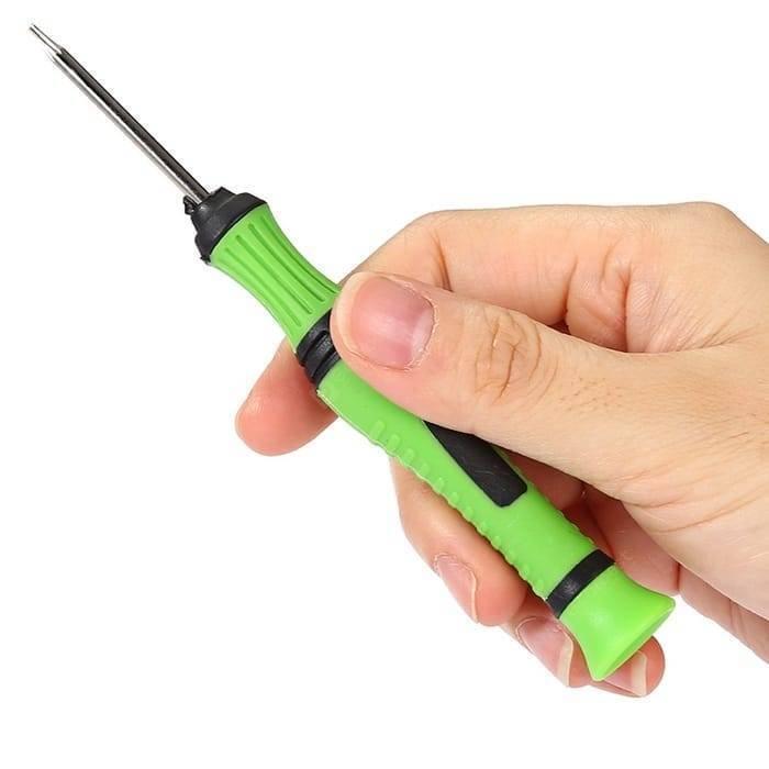 8pcs Multifunction Repairing Screwdriver Set Kit Maintain Disassemble Tools 8105 - a close-up of a hand holding a green and black precision screwdriver with a thin metal shaft.