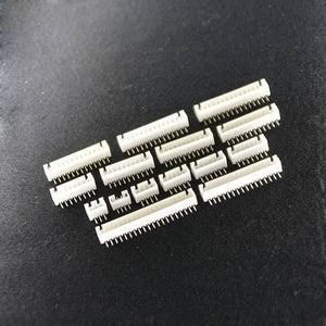 9 Pin 2.5mm JST Xh Style PCB Mount Male Connector - shown as a collection of various white plastic multi-pin headers with metal pins on a black surface.