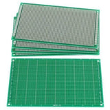 9CMX15CM Fr-4 Single Side Fiber Prototype Veroboard Stripboard PCB Circuit Board Dotted - stack of three green rectangular circuit boards with a single board laid flat in front.
