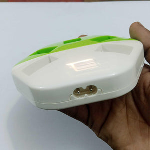 9V Universal Battery Charger - a white and green plastic device held in a hand, showing the two-pin power input connector on its side.