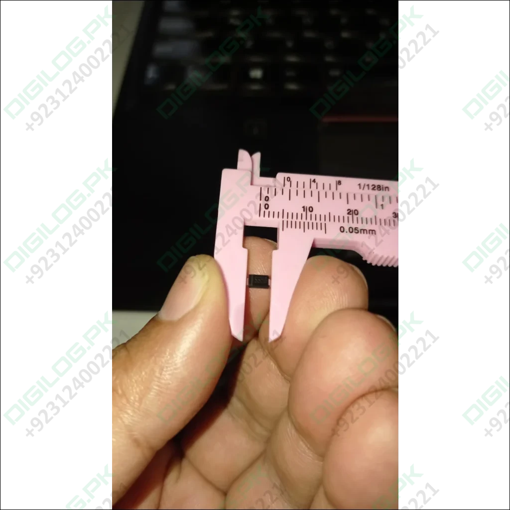Pink caliper measuring a small black SS56 diode in DO-214AA package in Pakistan