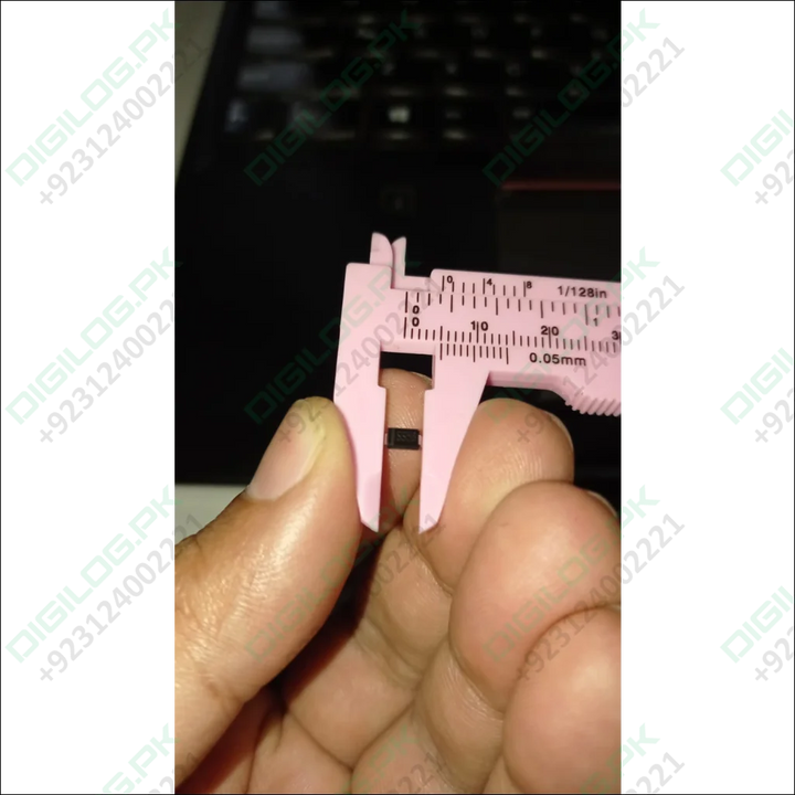 Pink caliper measuring a small black SS56 diode in DO-214AA package in Pakistan