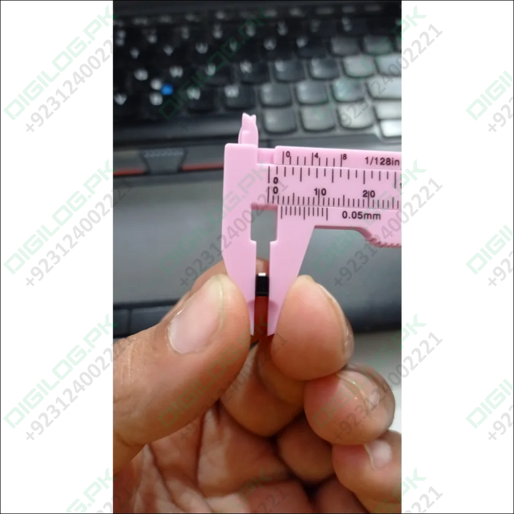 Pink caliper measuring SS56 diode in DO-214AA package, showcasing precision