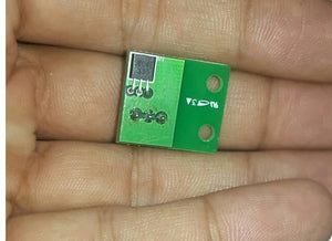 A1104E A04E New Original Hall Monopole Switch Small Volume TO-92uA - shown as a close-up of a small green circuit board with a black electronic component held in a person's hand.