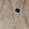 A3144E Hall Effect Sensor 44E - a close-up of a small black three-pin electronic component resting on a palm, with "3144" and "64551" printed on the face.