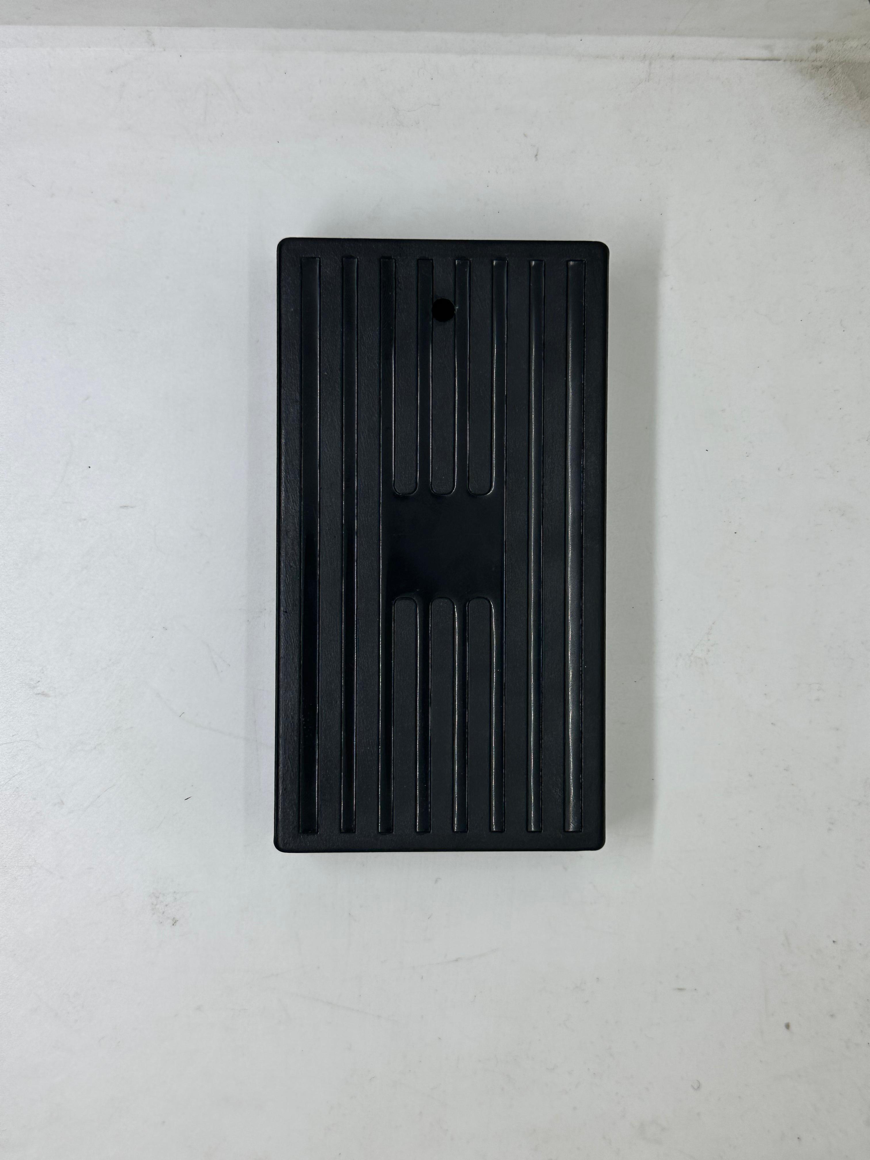 ABS Enclosure Box For WiFi Router - a rectangular black plastic case with a vertically ribbed surface and a single small circular hole at the top.