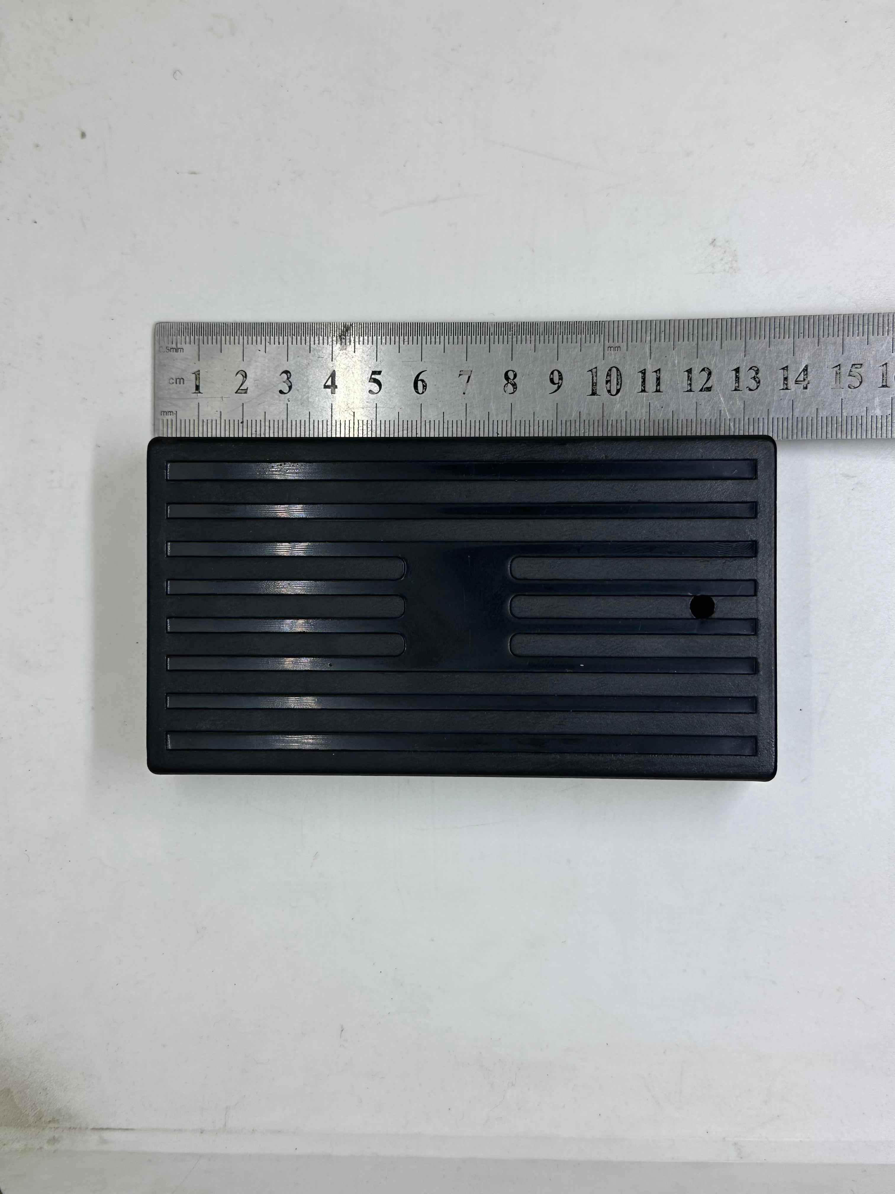 ABS Enclosure Box For WiFi Router - shown from the top, featuring a black rectangular ribbed plastic casing with a single small hole, next to a ruler.
