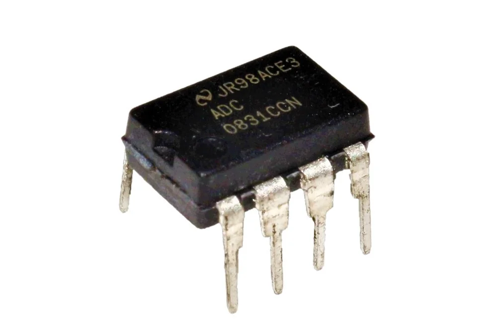 ADC0831 IC - a black 8-pin dual-inline package integrated circuit with silver pins, shown from an angled perspective against a white background.