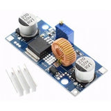 Adjustable DC To DC Step Down 5A Buck Converter With Heatsink XL4015 - the blue circuit board with two capacitors, an inductor, and a heatsink.