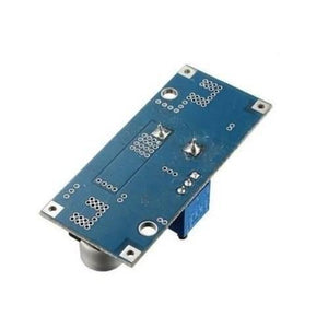 Adjustable DC To DC Step Down 5A Buck Converter With Heatsink XL4015 - the blue rectangular circuit board from the back with a metal potentiometer.