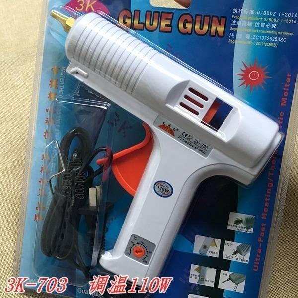 Adjustable Temperature Hot Glue Gun - in its original retail packaging, featuring a white body, an orange temperature control dial, and a black power cord.