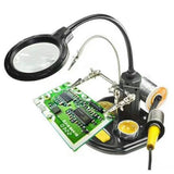 Advanced 2.5x-4x 16 SMD LEDS Desk Lamp Iron Soldering Base Magnifier Glass Helping Hand Station Stand - holding a green circuit board with metal clips.