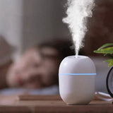 Air Humidifier USB Small 220 ML Mini Portable Cool Mist Diffuser For Bedroom Office Desk Car Travel Atomizer,white - oval-shaped device emitting a cool mist with a glowing blue light ring.
