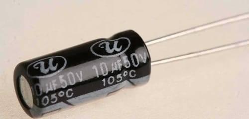 Aluminum 10uF 50V Electrolytic Capacitor - shown as a black cylindrical component with two metal leads and printed text indicating 10uF 50V 105°C.