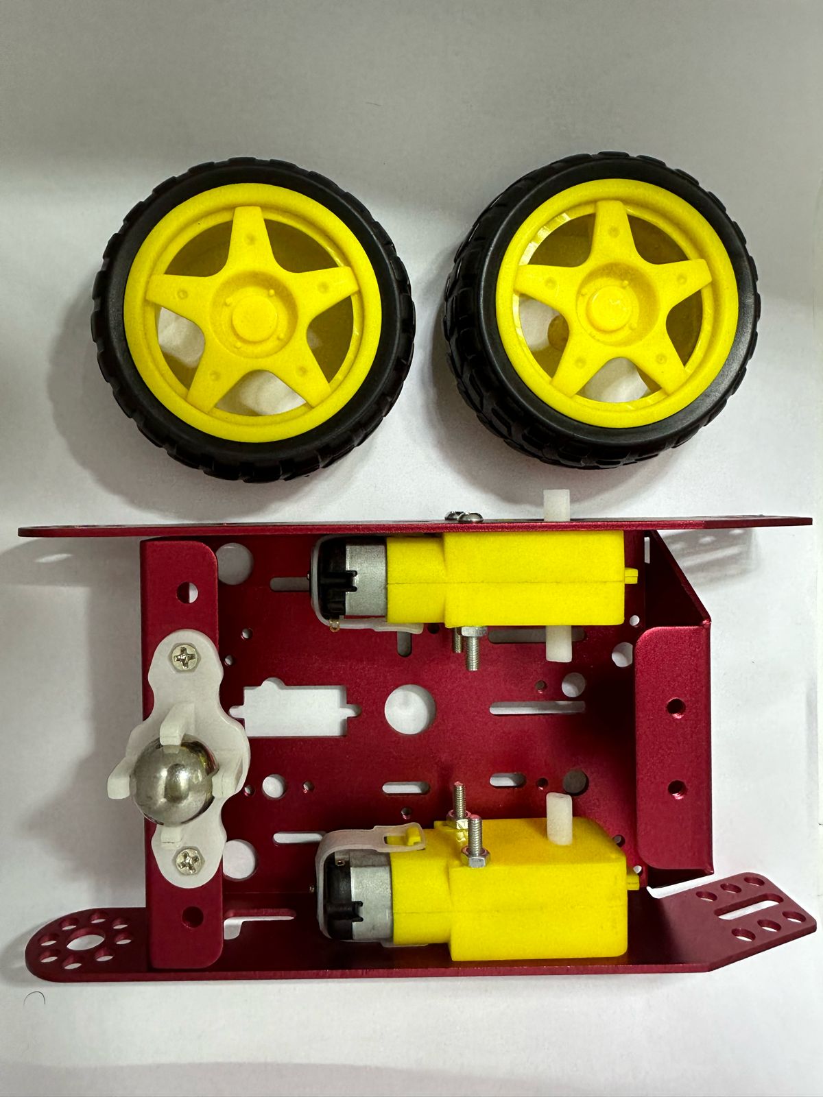 Aluminum 2wd Tt Robot/motor Chassis - shown with a red metal frame, two yellow motors, two yellow and black wheels, and a white caster wheel.
