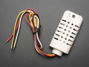 AM2302 Temperature And Humidity Sensor - a white rectangular sensor module with a vented casing and four multi-coloured wires extending from one end.
