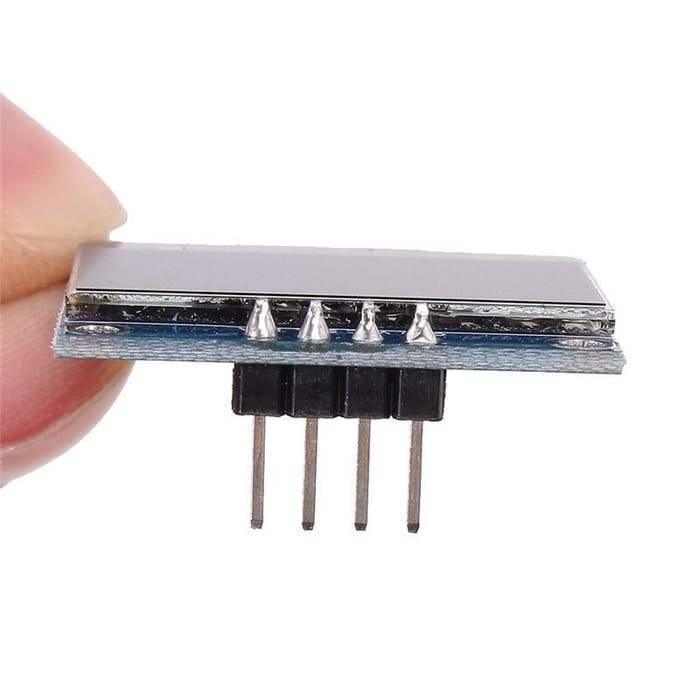 Arduino 0.96 Inch OLED Display Module 128x64 I2c SSD 1306 LCD Screen White Background - a close-up side view showing the rectangular screen mounted on a blue circuit board with four downward-facing pins.