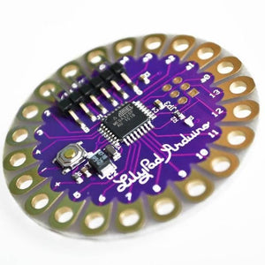 Arduino Lilypad Arduino 328 Main Board ATMEGA328P ATMEGA328 16M - a circular purple microcontroller board featuring a central ATMEGA328P chip, a reset button, and pin holes.