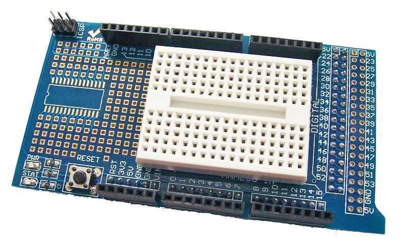 Arduino Mega Proto Shield - a blue circuit board with a white breadboard, a reset button, ICSP header, and various labeled pin headers.