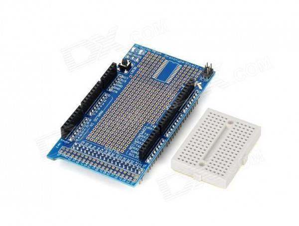 Arduino Mega Proto Shield - shown with a blue printed circuit board featuring pin headers, a reset button, and an included small white breadboard.