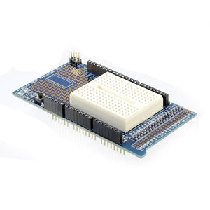 Arduino Mega Proto Shield - a blue circuit board with a white mini breadboard, a reset button, and black pin headers on a white background.