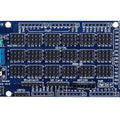 Arduino Mega Sensor Shield - a blue rectangular circuit board featuring numerous pin headers, a reset button, a terminal block, and various labeled ports.
