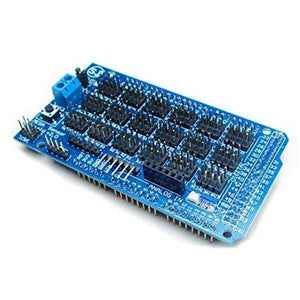 Arduino Mega Sensor Shield - a blue rectangular circuit board featuring multiple pin headers, a reset button, and a two-terminal screw connector.
