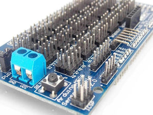 Arduino Mega Sensor Shield - a blue circuit board featuring multiple rows of pin headers, a blue screw terminal, a reset button, and an ICSP header.