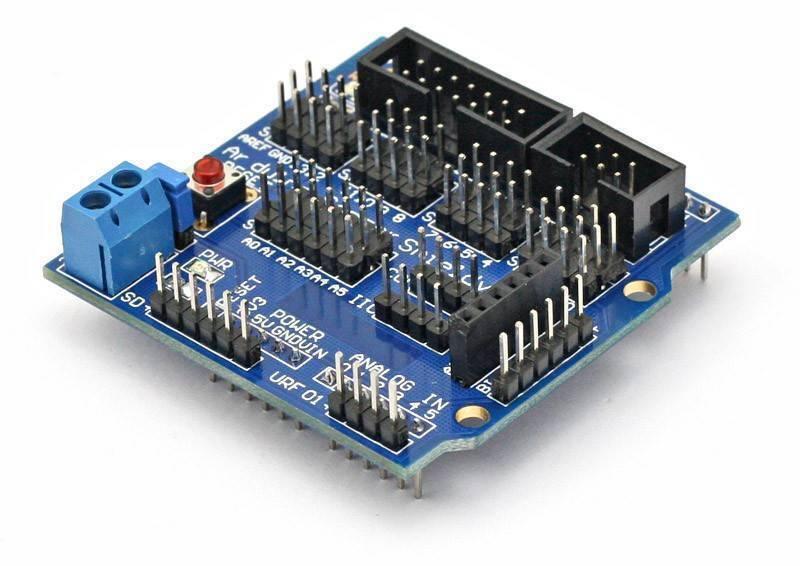 Arduino Sensor Shield V5 Expansion Board For Arduino - a blue rectangular circuit board with numerous pin headers, a reset button, and a blue terminal block.