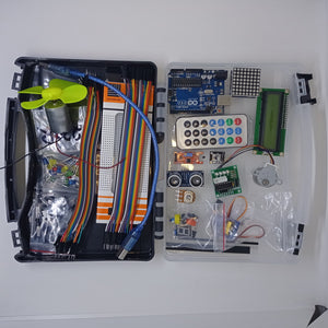 Arduino Starter Kit - shown in an open black plastic carrying case containing an Arduino Uno, LCD screen, remote, motor, breadboard, and various components.