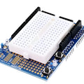Arduino Uno Proto Shield With Syb-170 Mini Breadboard - a white breadboard, two push buttons, two LEDs, and pin headers on a blue circuit board.